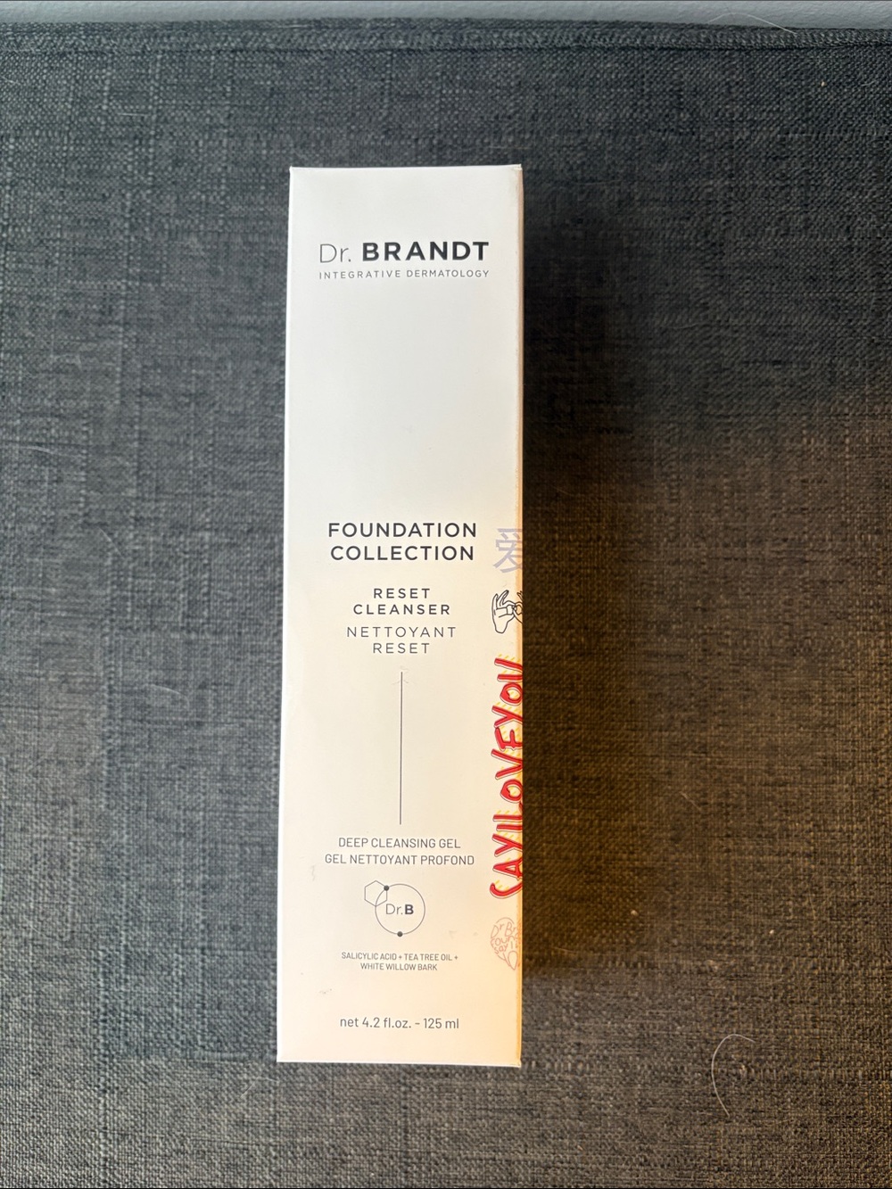 Dr. Brandt Reset Cleanser in White Packaging with Red Accent